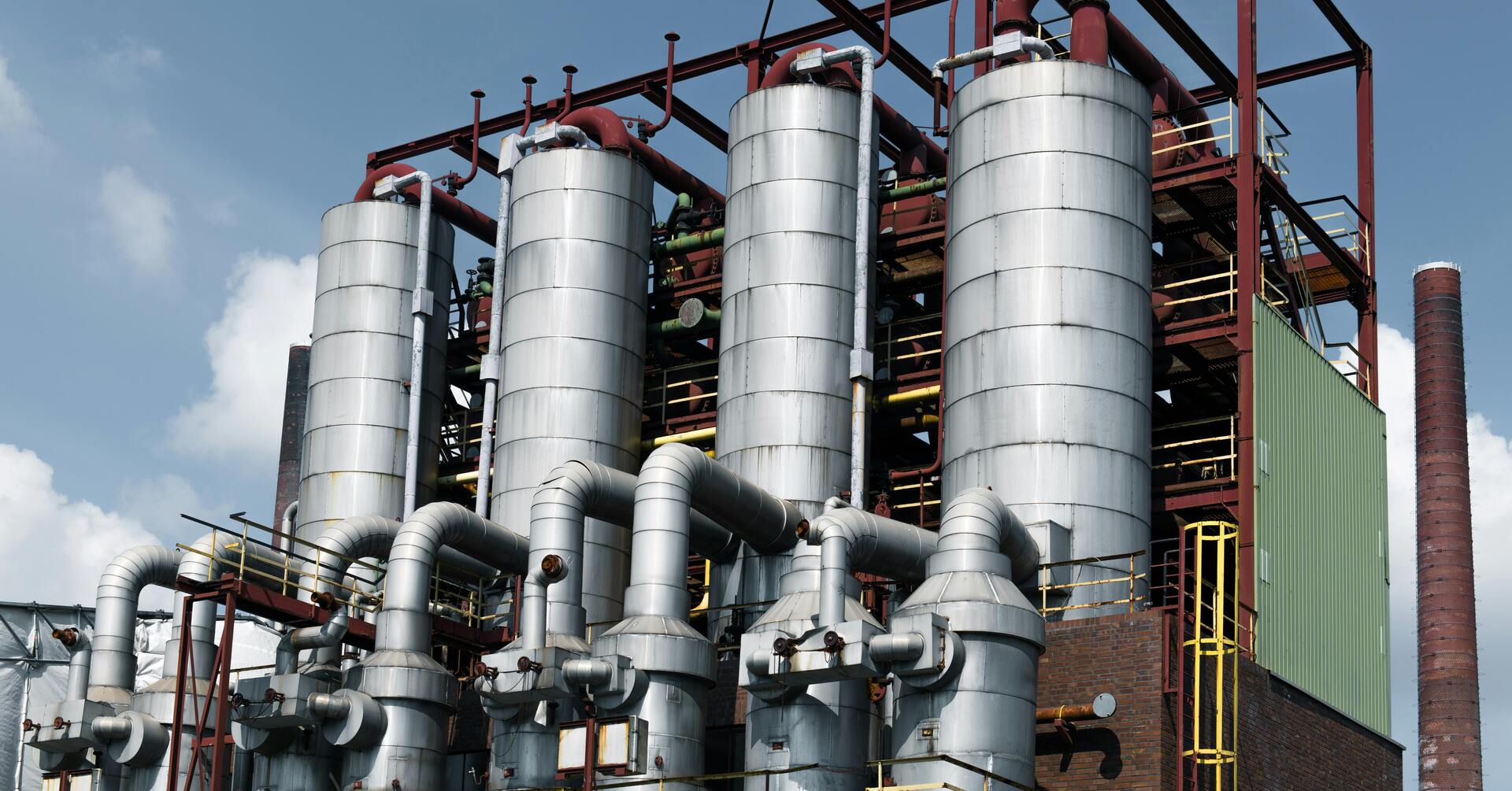 Four industrial boilers on a construction site