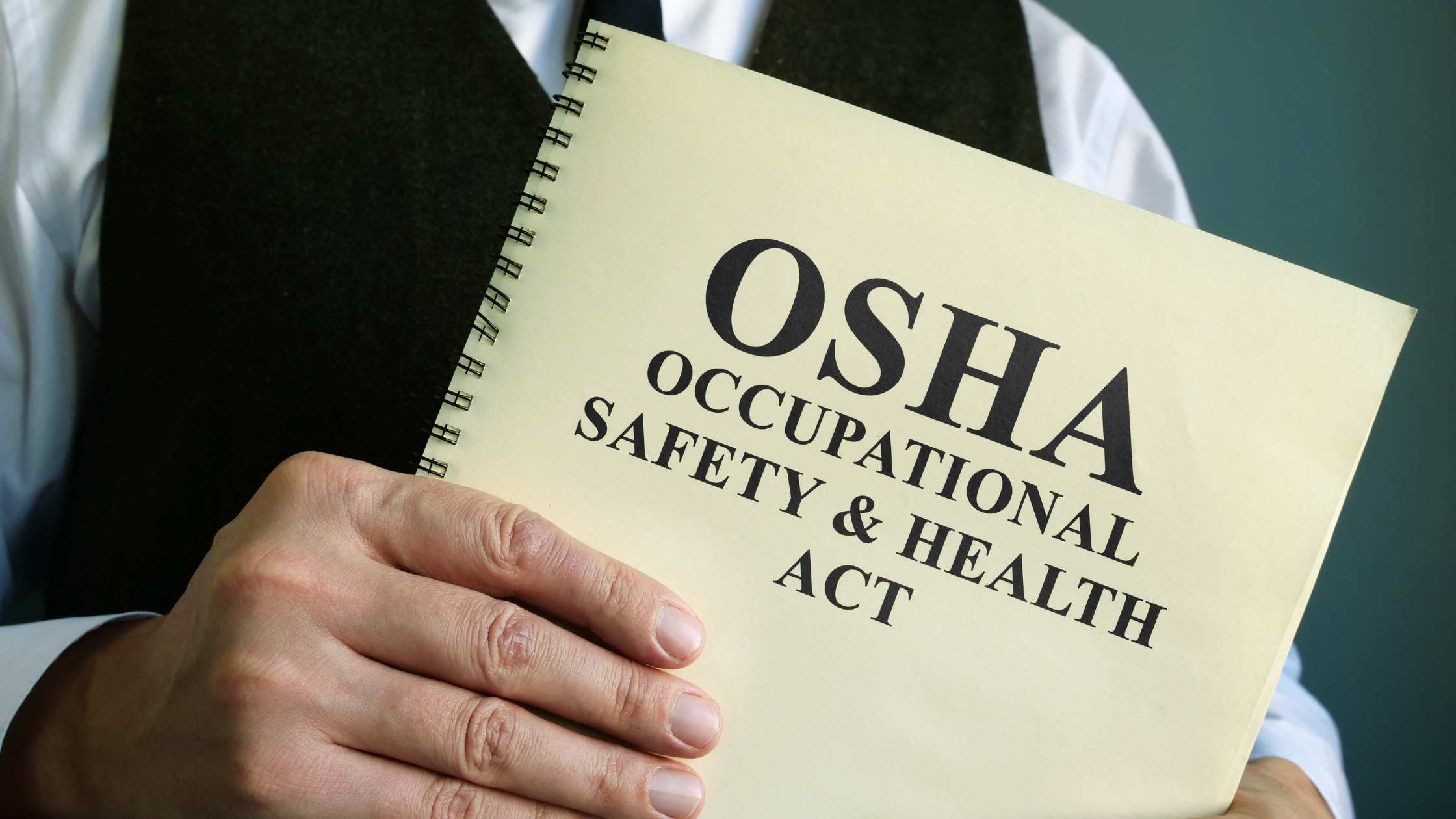 Man holding OSHA book