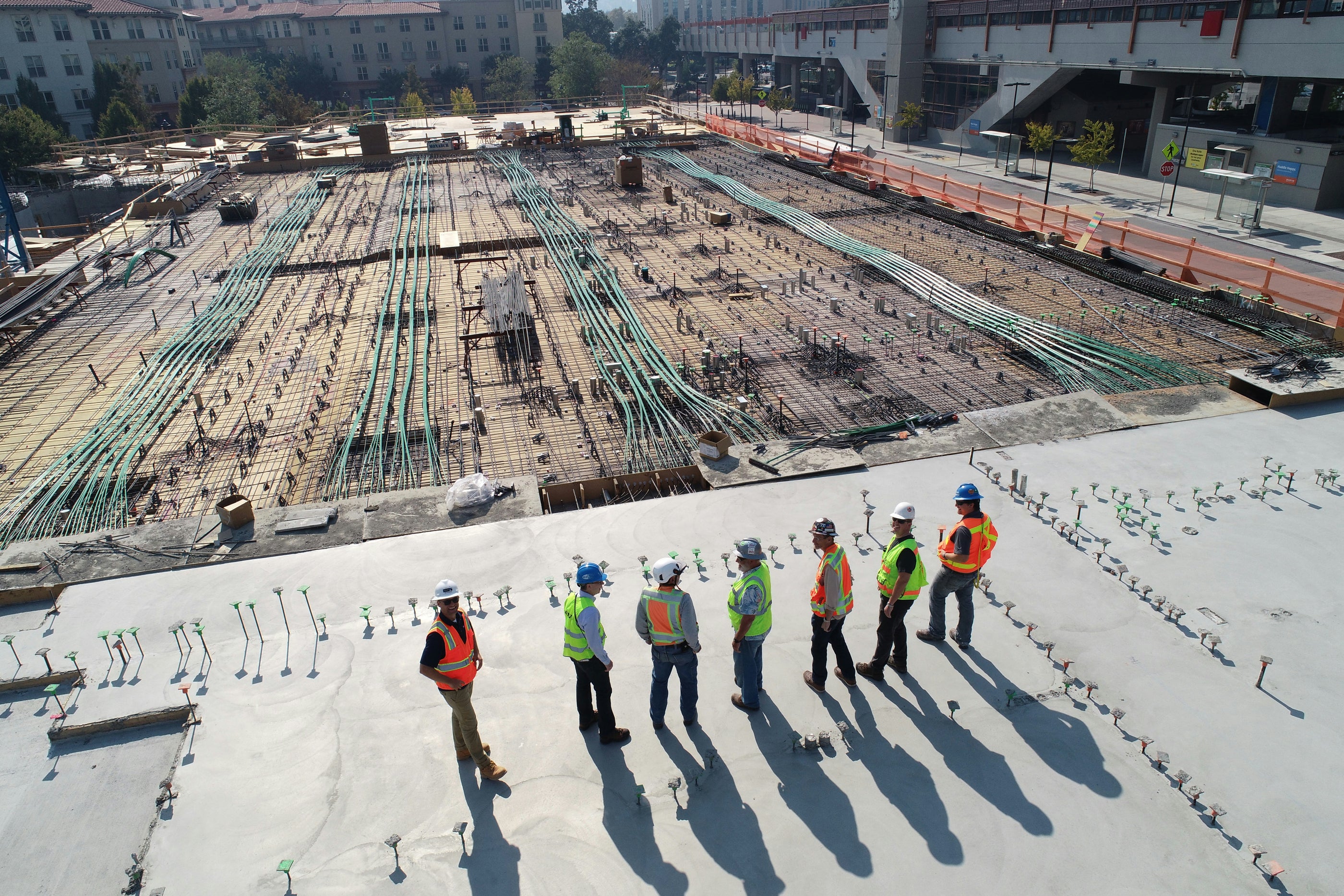 Seven construction workers on a maintenance meeting before shift