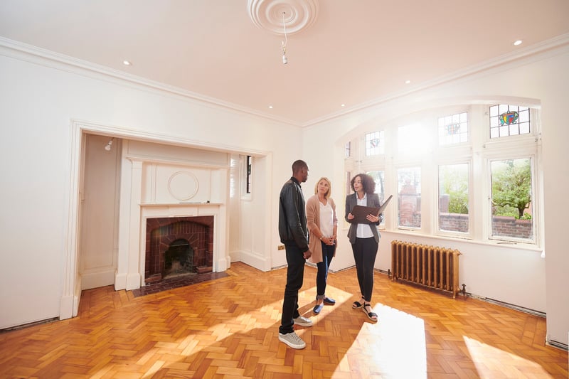 An estate agent shows a couple around the property